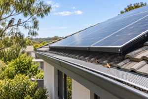 Mesh barrier fitted beneath solar panels